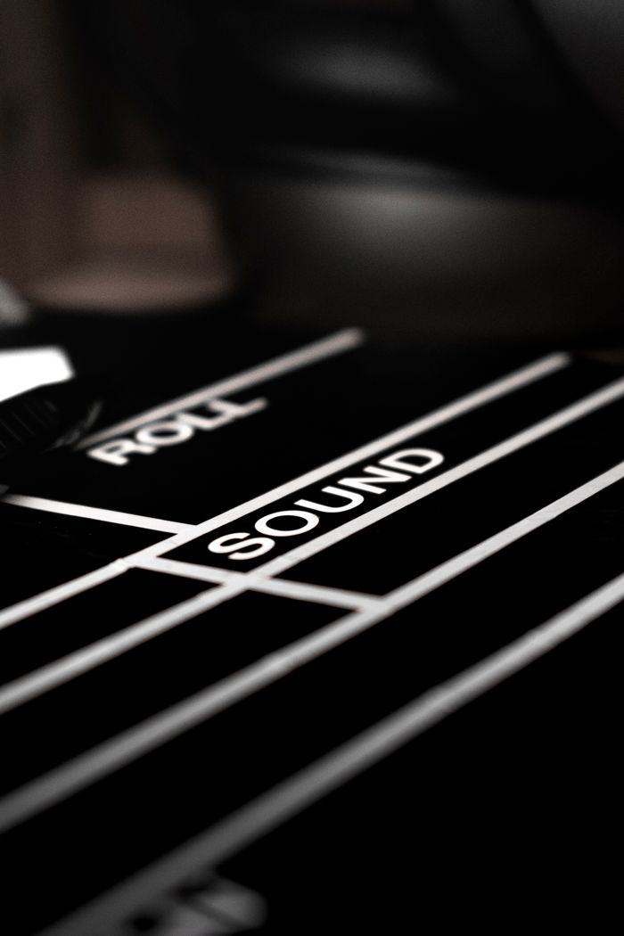 services-04 Artistic black and white close-up of a film clapperboard focused on the word 'SOUND'.