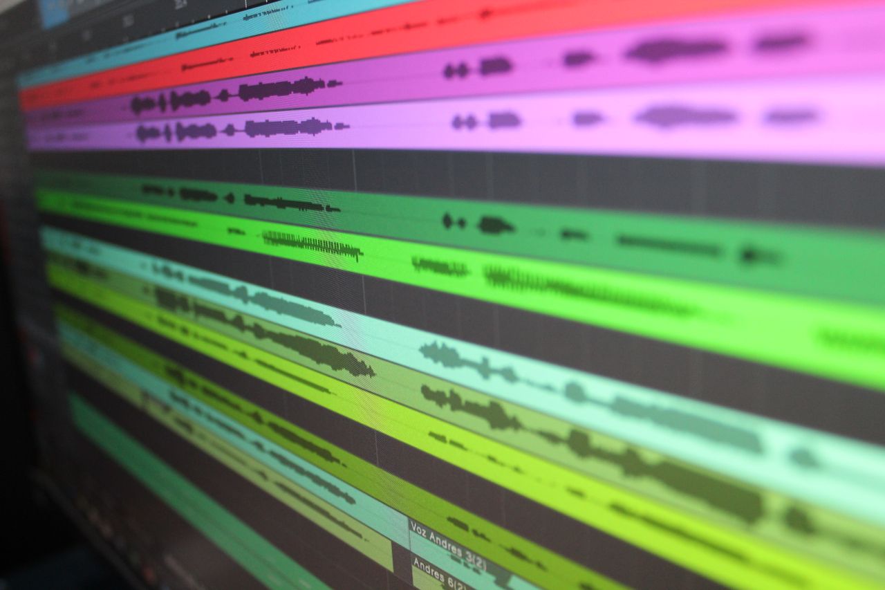 services-06 Close-up of audio waveforms on screen, showcasing music production software in use.