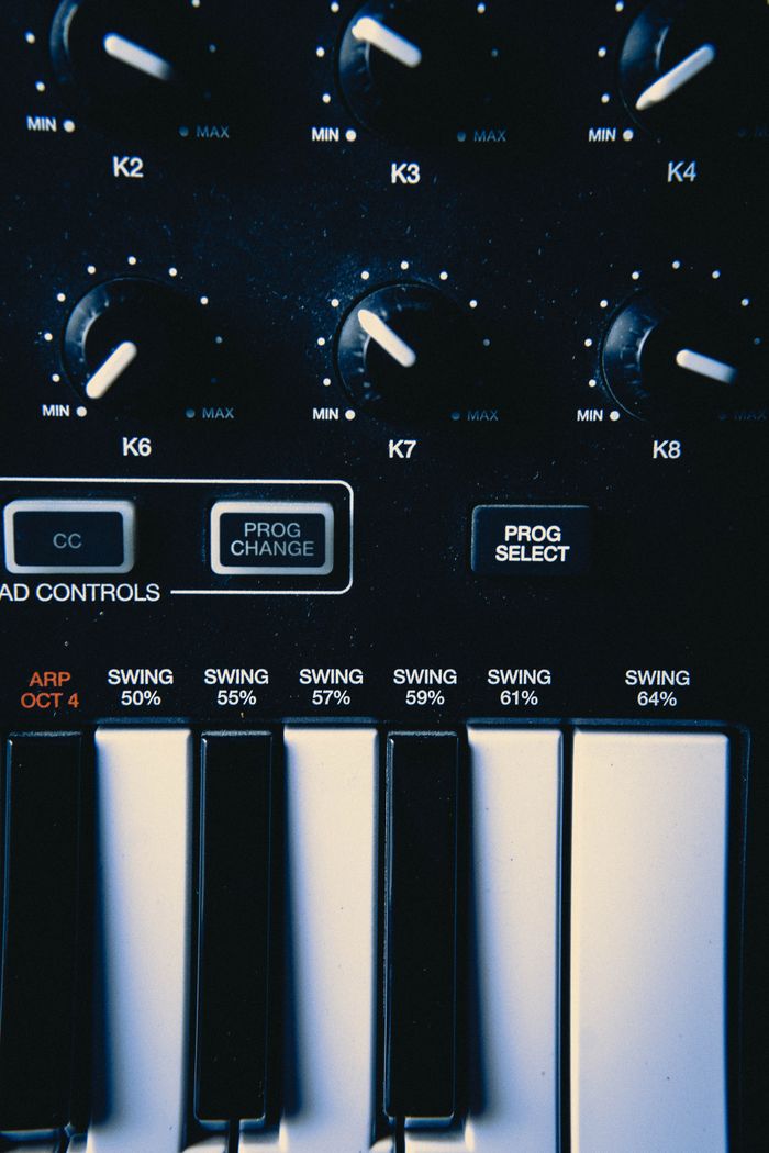 Detailed view of a keyboard with control buttons and piano keys, perfect for music technology themes.